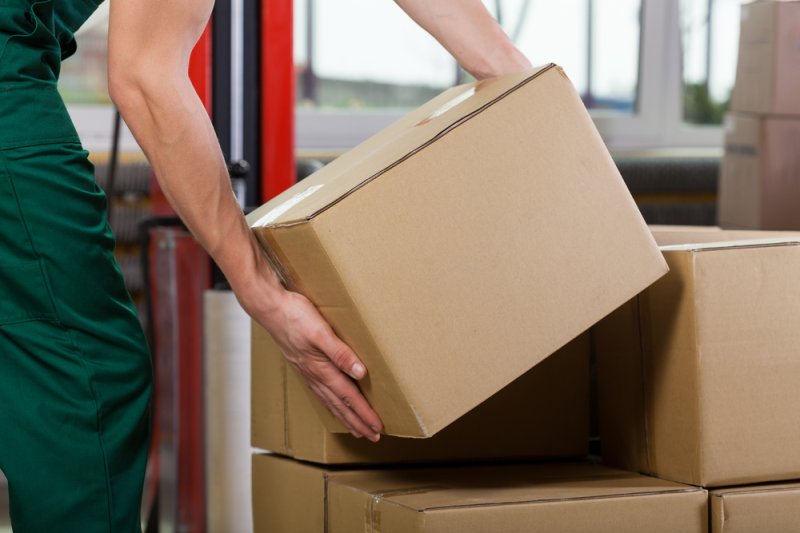 Man lifting cartons in a store stockroom | Martec International