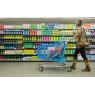 Woman pushing a cart down a grocery aisle | Martec International
